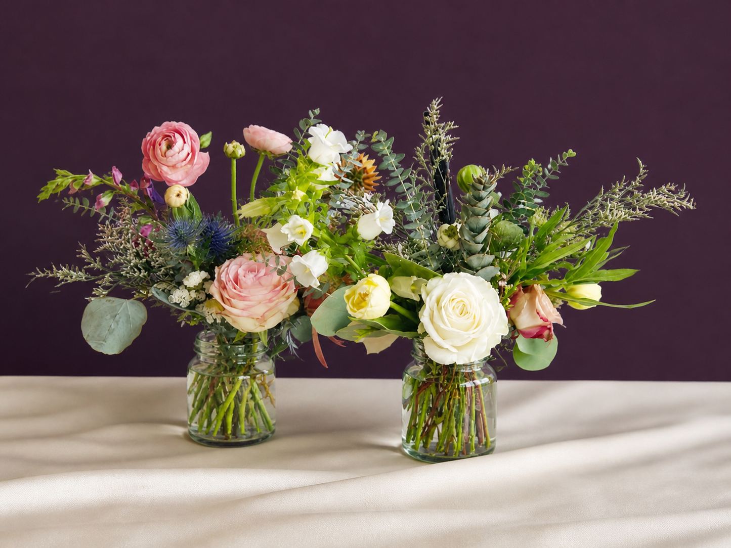 2 small flower arrangements in jars