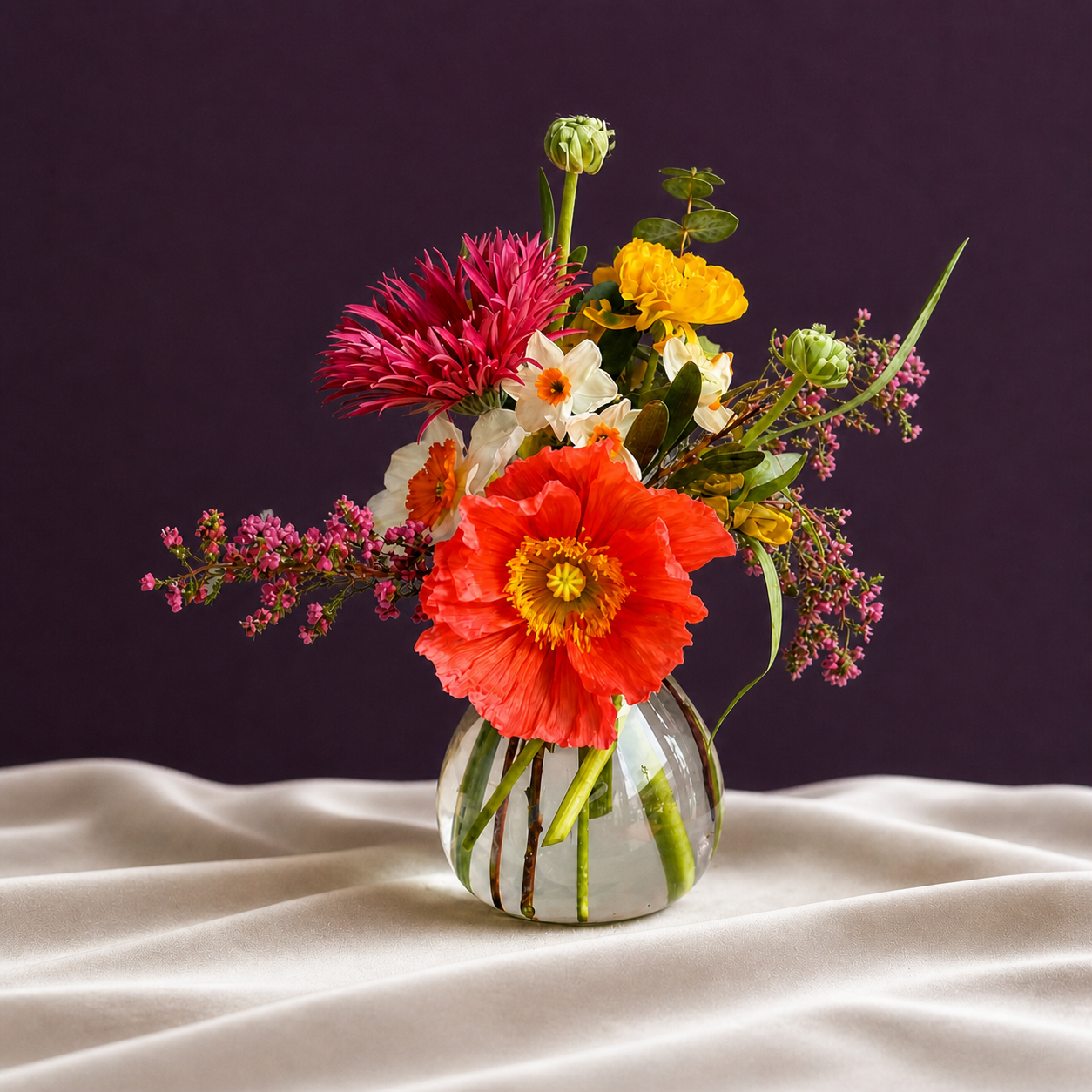 Bud vase of flowers on cloth